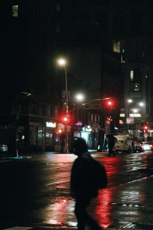 Person Walking on Street during Night Time