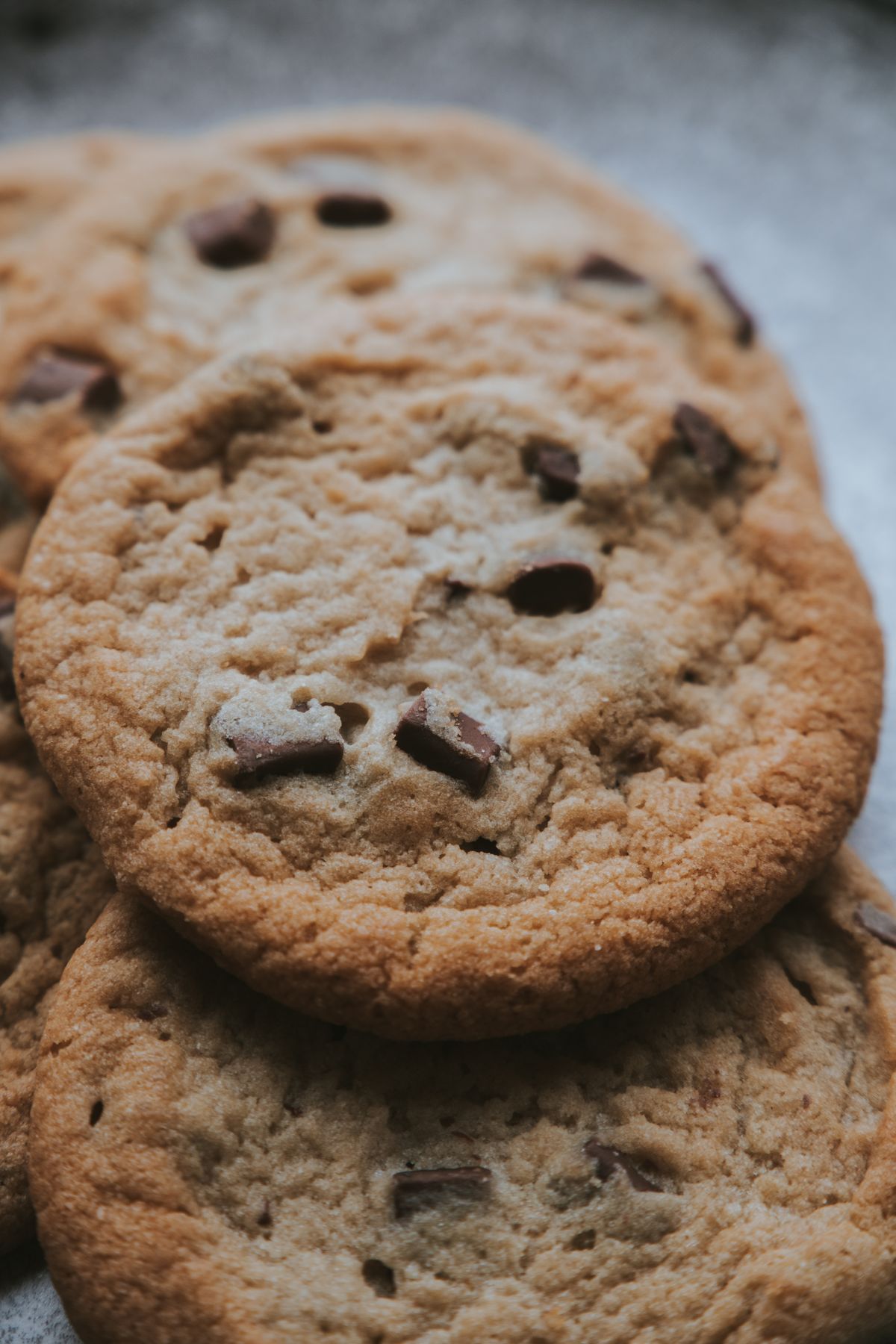 Real chocolate chip cookies photographed in a close-up food styling scene