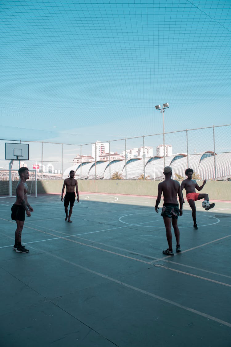 Players Playing Soccer On A Basketball Court