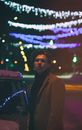 Woman in Brown Coat Standing Near Car during Night Time