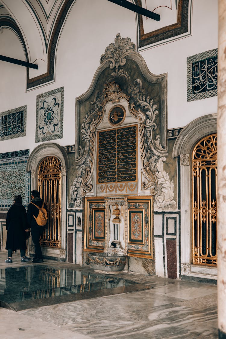 A Couple Walking Inside Topkapi Palace Museum In Istanbul