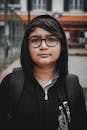 Woman in Black Hoodie Wearing Eyeglasses
