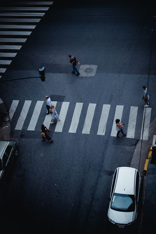 Free People crossing a street in Buenos Aires at a zebra crossing from an aerial view. Stock Photo