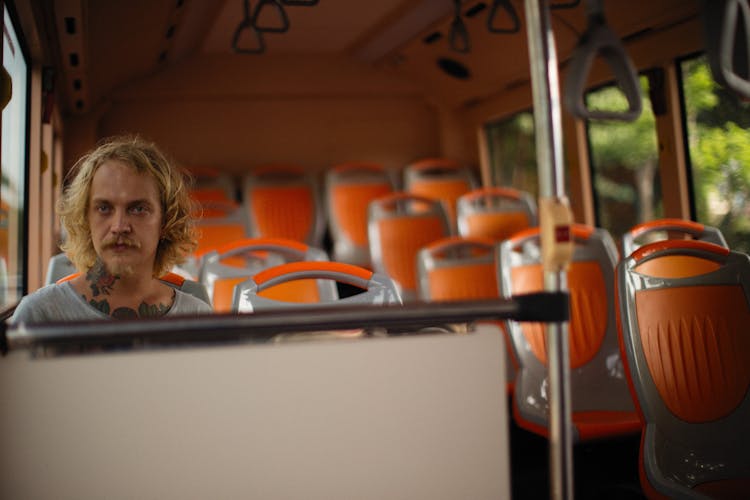 Man Sitting On Bus Seat