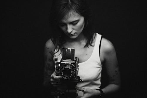 Free Woman Taking a Photograph with a Vintage Camera  Stock Photo