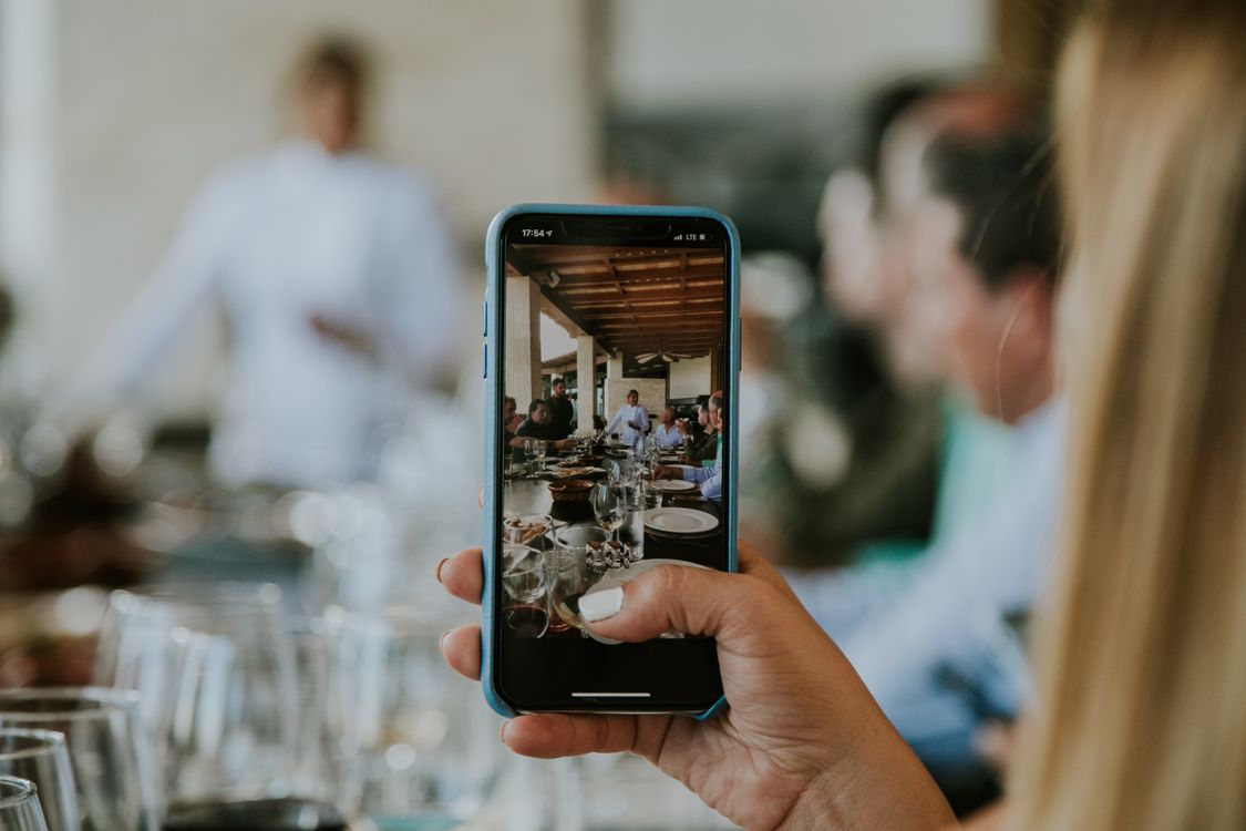 smartphone capturing dining restaurant UGC