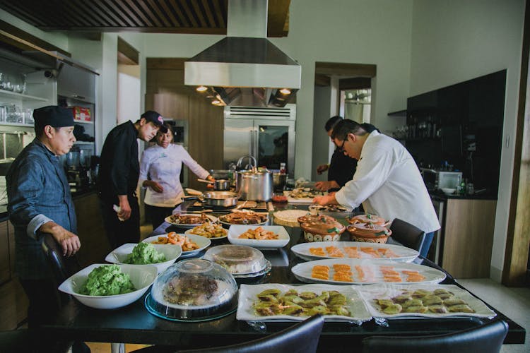 Chefs Preparing Food In A Kitchen