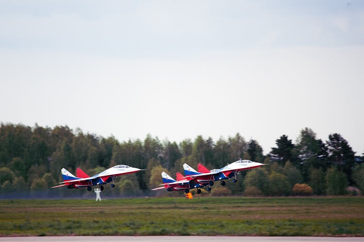 Jet Aircrafts Takeoff On Green Grass Field