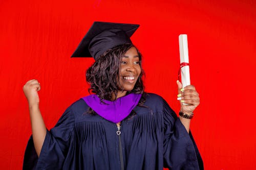 Free A Smiling Woman Holding Her Diploma Stock Photo