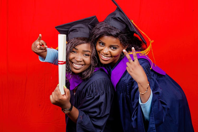 Happy Women Wearing Graduation Hats