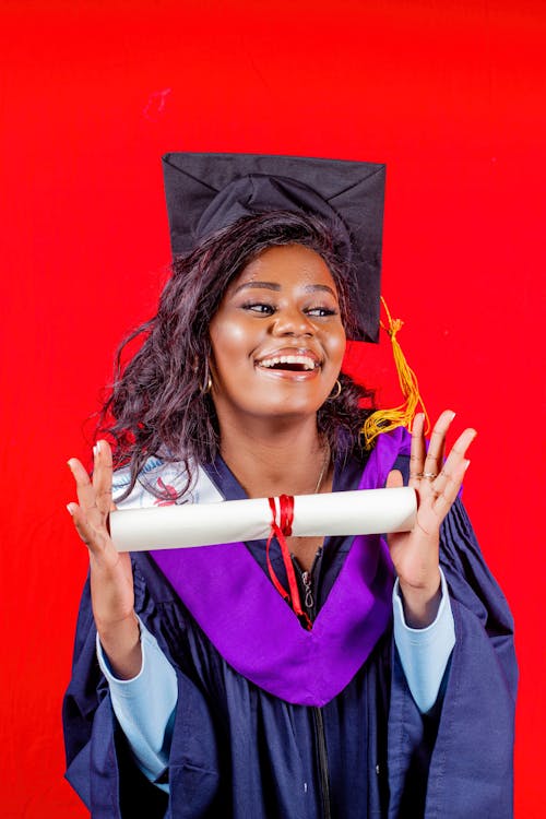 A Happy Woman Posing with a Diploma