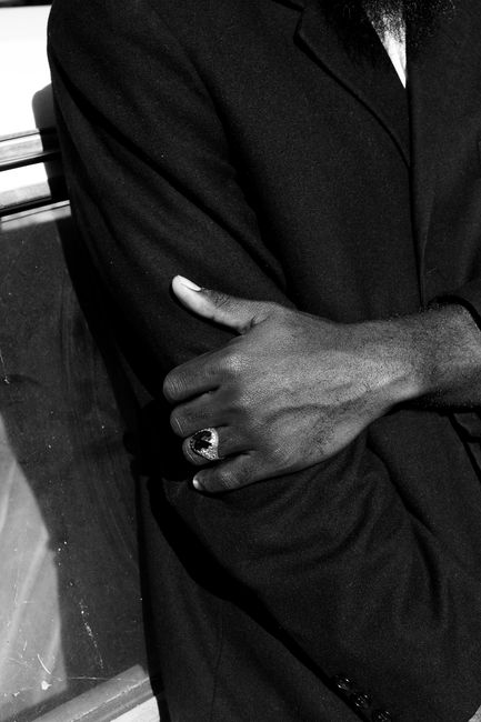 Close-up of a man's hand wearing a ring in a monochrome portrait, Abuja, Nigeria.