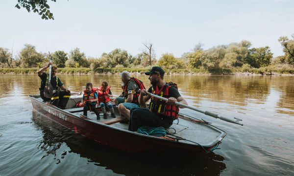 Family on boat with children wearing life jackets