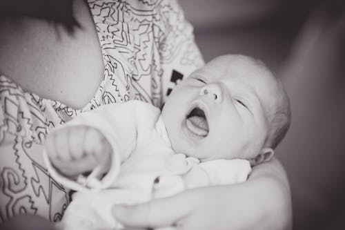 Free Close-Up Shot of a Person Carrying a Baby Stock Photo