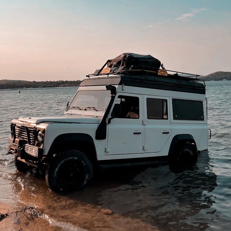 A Land Rover Defender In The Water 