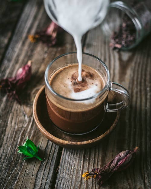 Free Milk Added to Cup of Hot Chocolate Stock Photo
