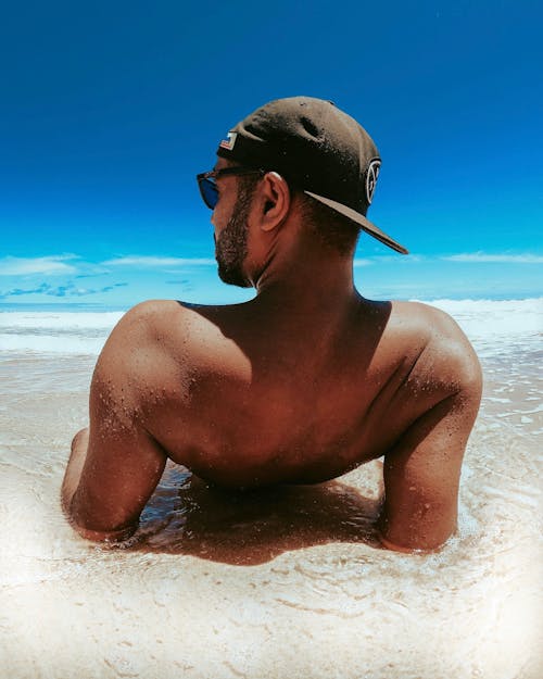 Man Wearing Cap on a Beach
