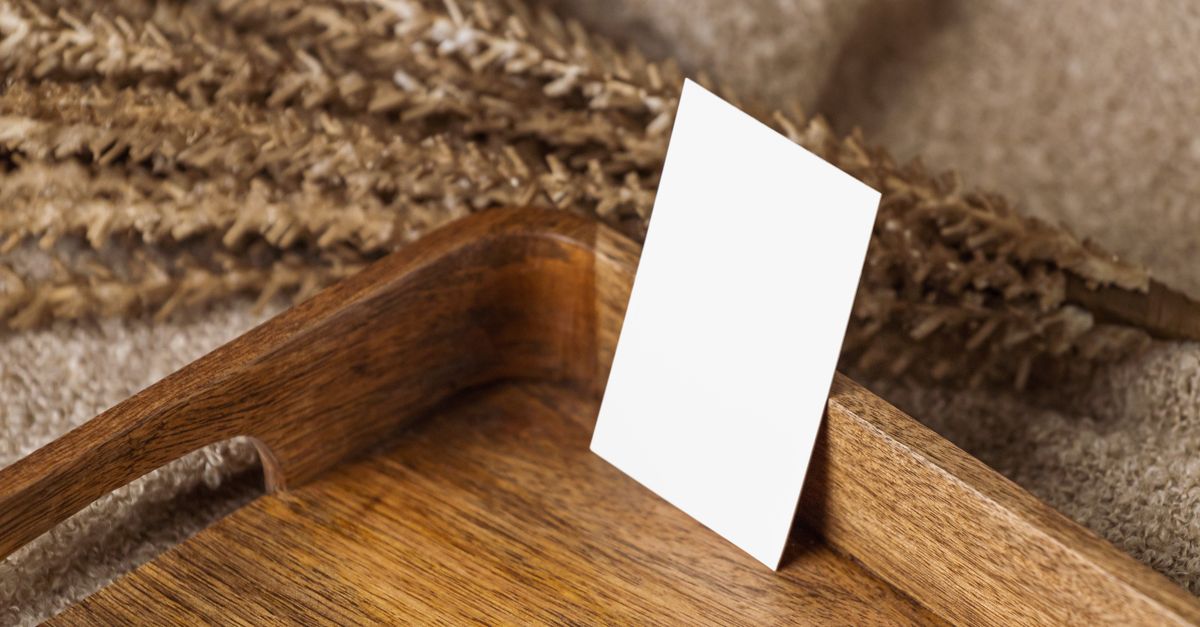 Blank business card on a wooden tray with dried wheat. Ideal for branding or design mockups.
