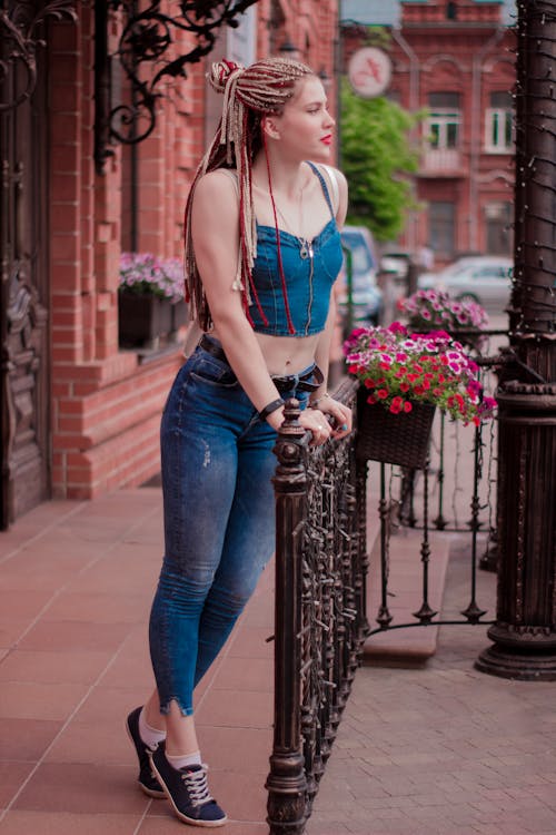 Woman Wearing Blue Crop Top Holding Handrails