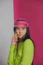 Woman Wearing Pink Visor Talking on Phone