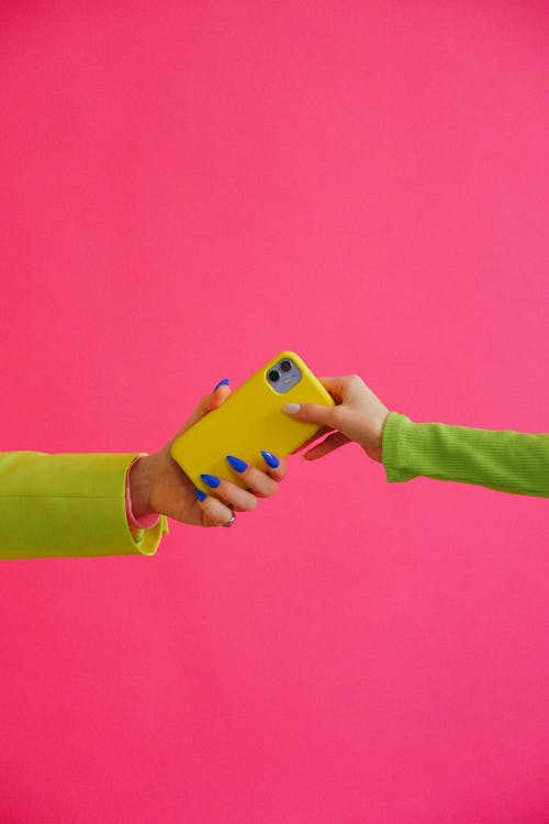 Free Hands Handing Phone to One Another Stock Photo