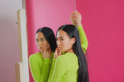 Free Woman in Green Sweater Standing by Full Length Mirror Stock Photo