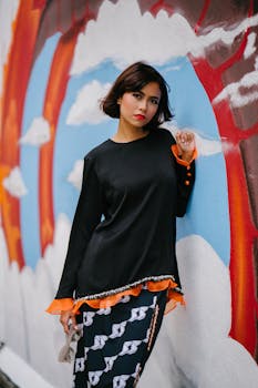Woman Wearing Black Long-sleeved Shirt Learning on Wall