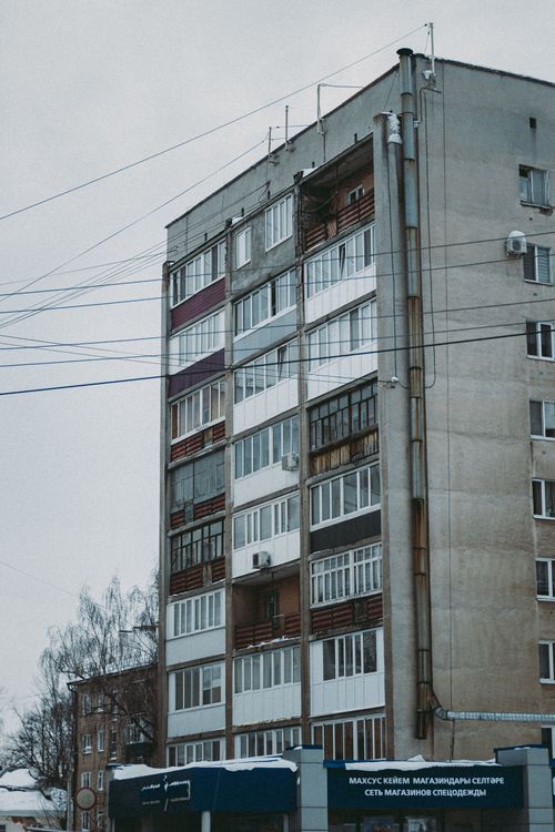 Free Vertical view of a Soviet-style apartment building during winter season. Stock Photo