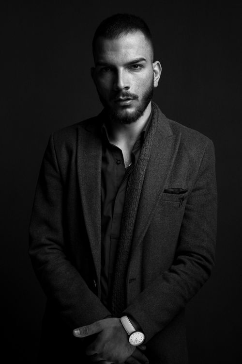 Free Elegant black and white portrait of a man in formal attire, captured during a studio photoshoot. Stock Photo