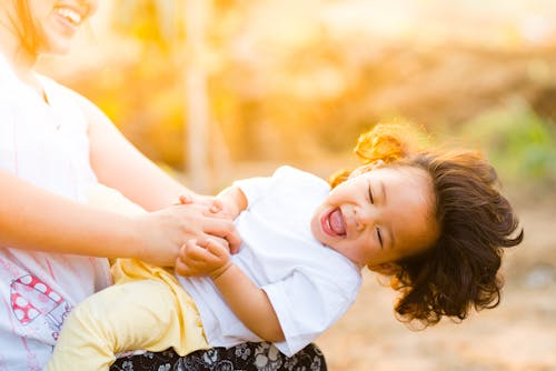 Woman Holding Baby Smiling