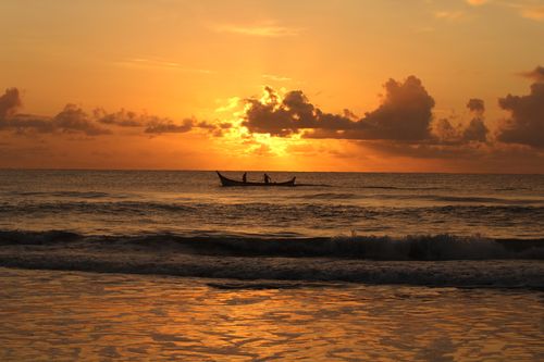 Free A serene boat silhouette sailing during sunset on Guaratuba's coastline, capturing calm and beauty. Stock Photo