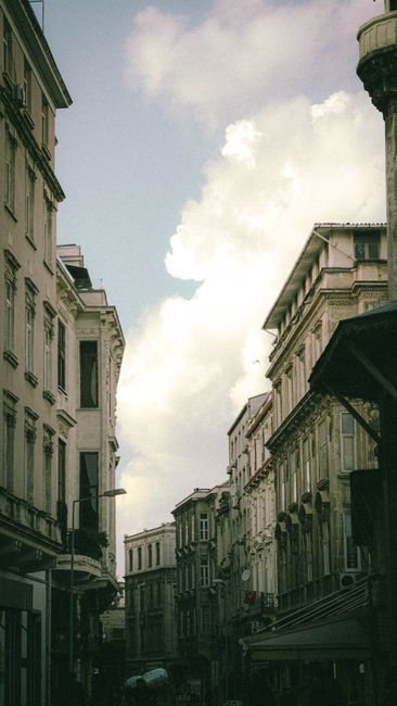 A picturesque view of a historic street lined with classic buildings under a cloudy sky.