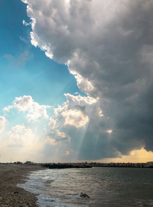 Free A striking view of clouds over the sea at Tartus Beach, Syria, capturing nature's dramatic beauty. Stock Photo