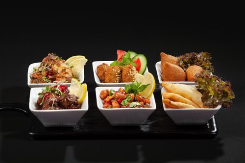 Free A diverse Middle Eastern appetizer platter with tasty dishes presented in white ceramic bowls. Stock Photo