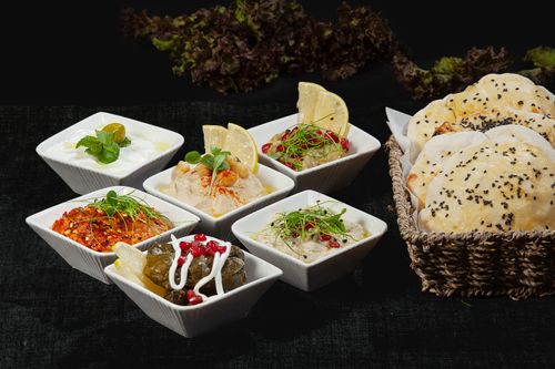 Free A delectable assortment of Middle Eastern dips and bread with fresh herbs and spices. Stock Photo