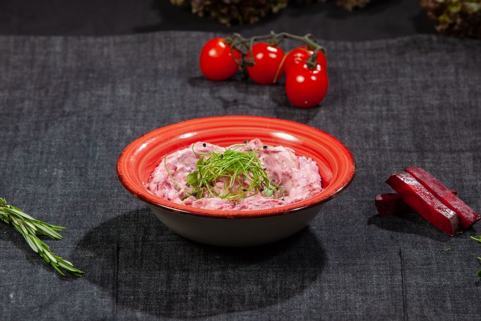 Discover a vibrant beetroot salad garnished with fresh greenery, perfect for healthy meals.