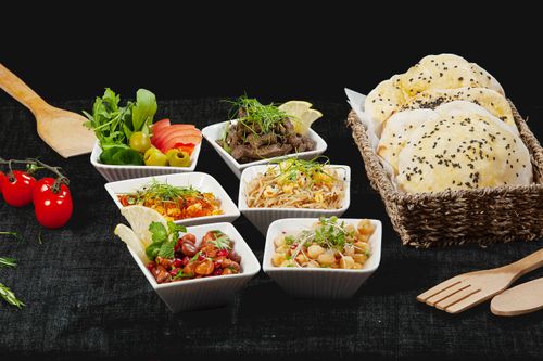 Free A vibrant mezze platter with Middle Eastern dishes and fresh bread, perfect for sharing. Stock Photo