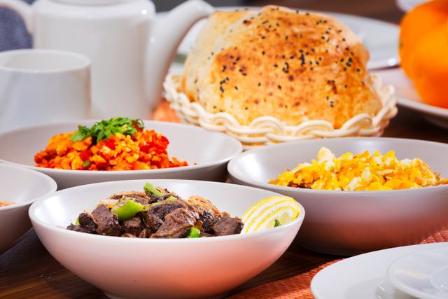 Delicious assortment of colorful dishes in bowls with bread, perfect for a food-centered stock photo.