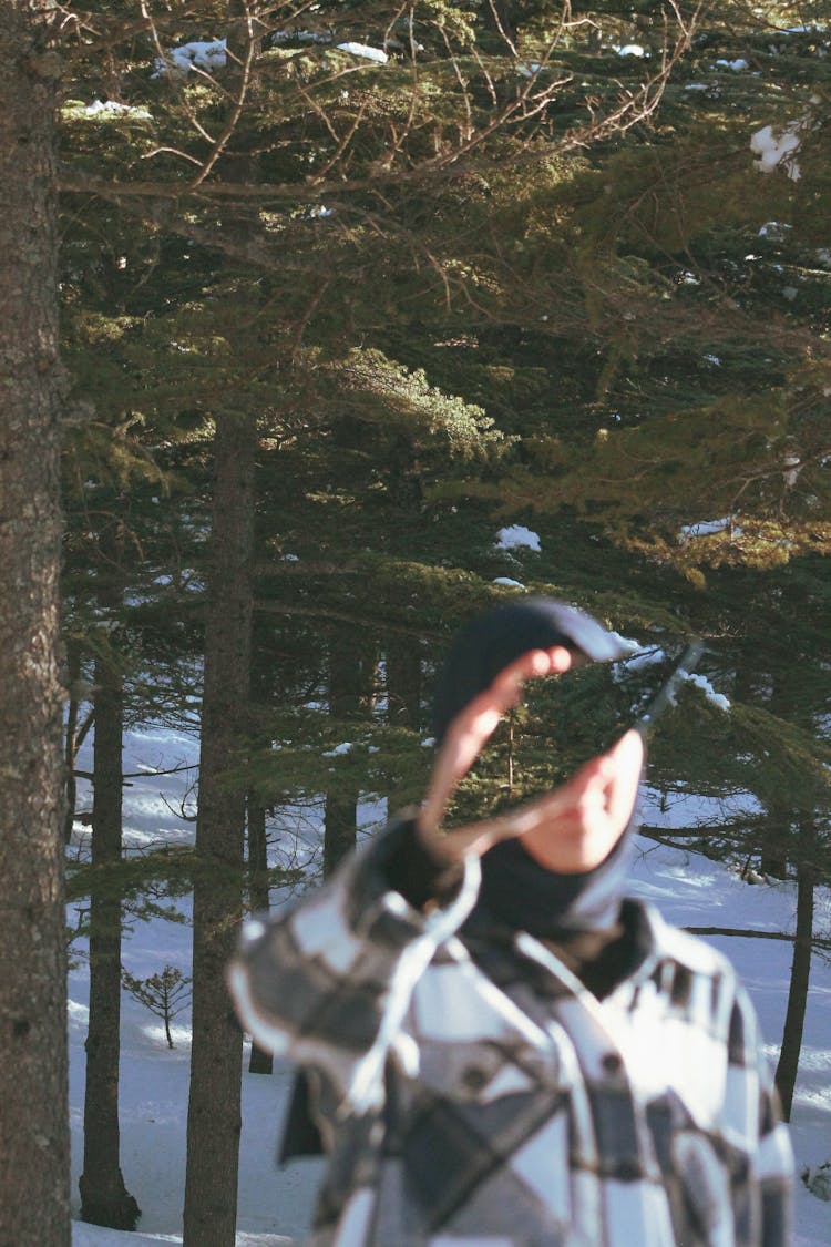 Person Hiding Face Behind Piece Of Mirror