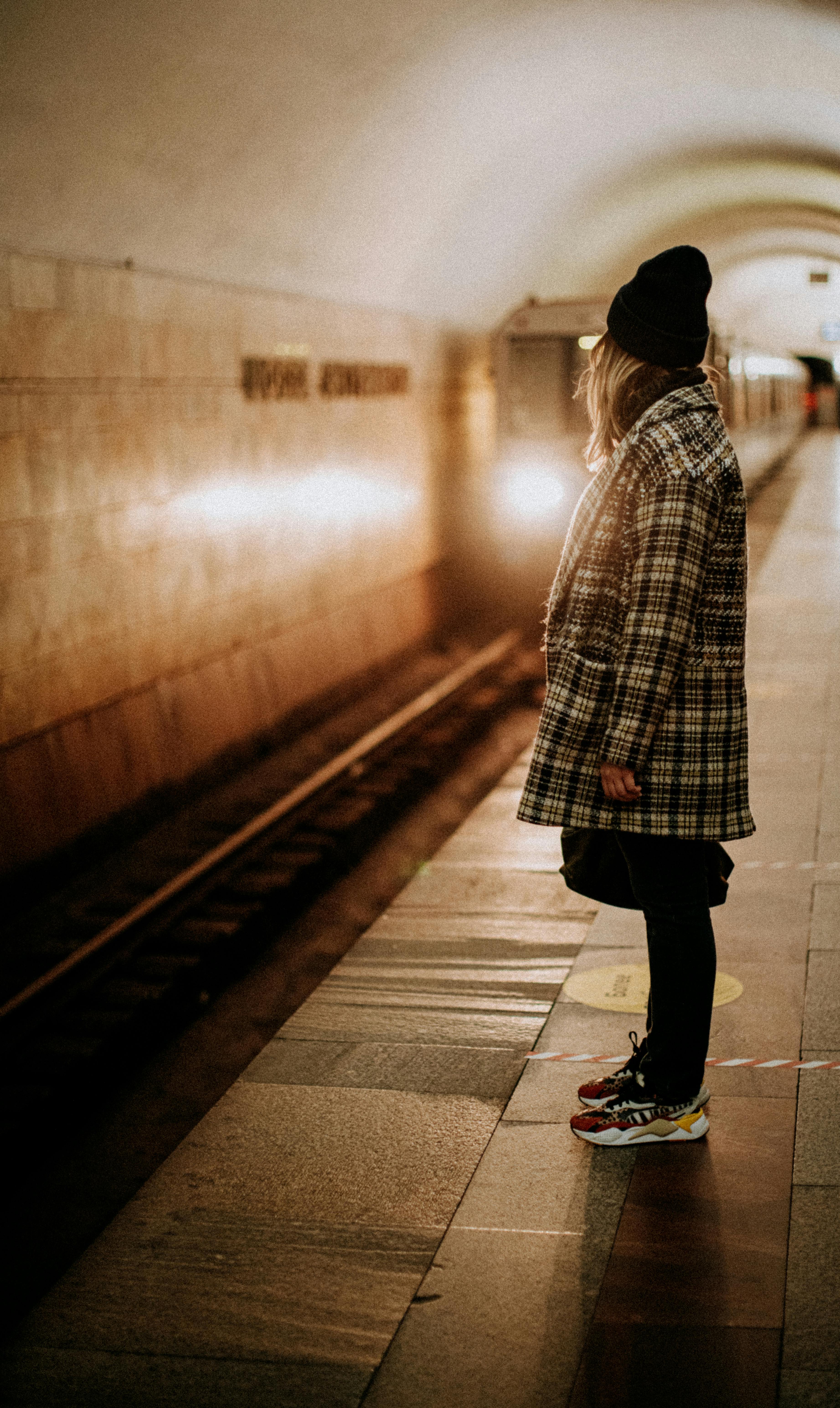 woman standing on subway platform