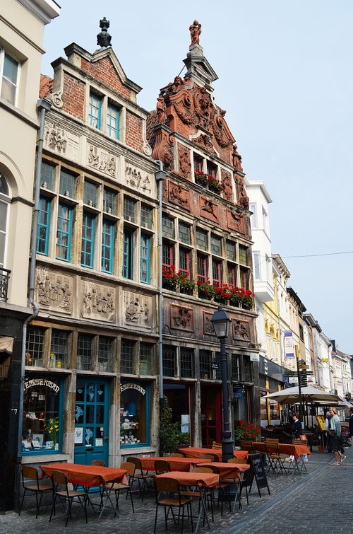 Free European street scene showcasing ornate historic buildings and outdoor cafés. Stock Photo