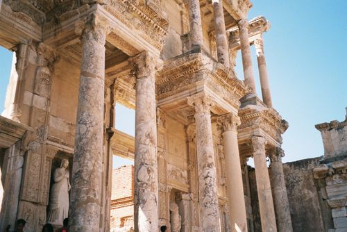 Free Ruins of the Library of Celsus in Ephesus with detailed columns and sculptures, under clear blue sky. Stock Photo