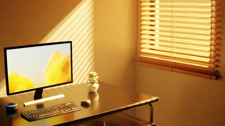 Computer On A Table Near Window 