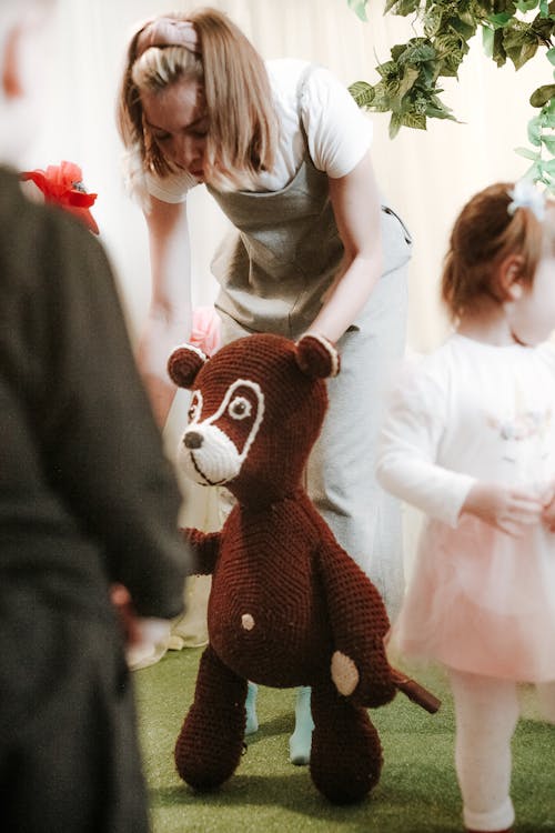 A Woman Holding a Stuffed Tot