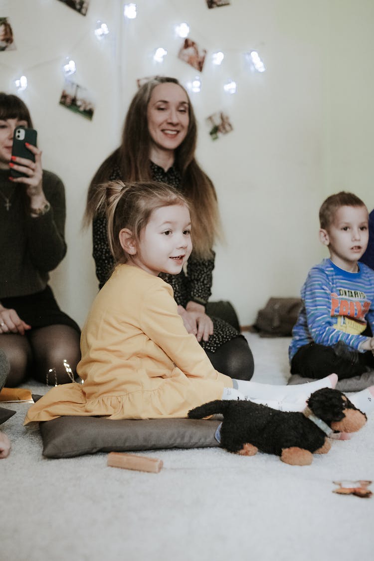 Children And Moms Sitting On Floor In Kindergarten