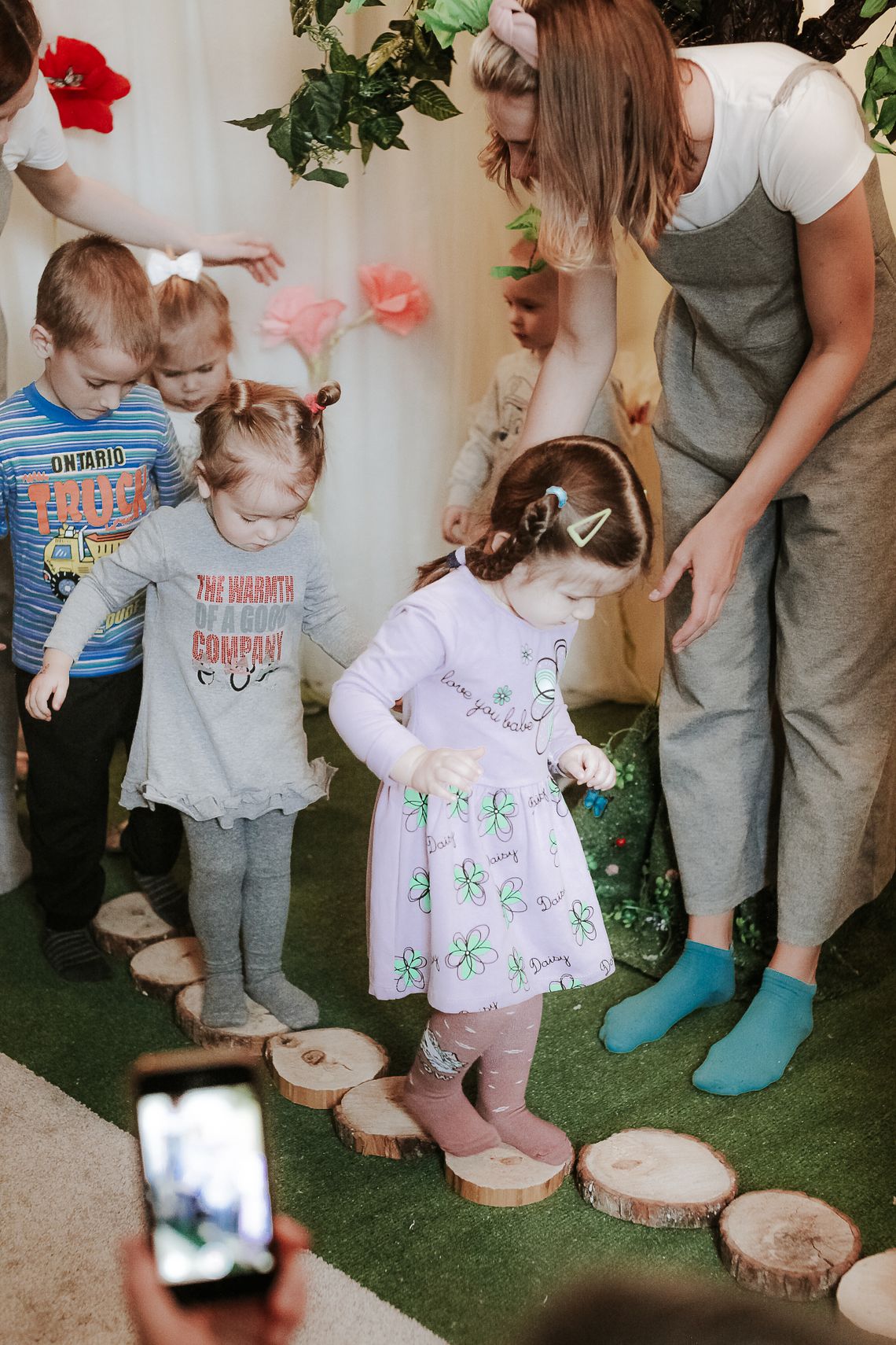 Children participating in a guided preschool movement activity