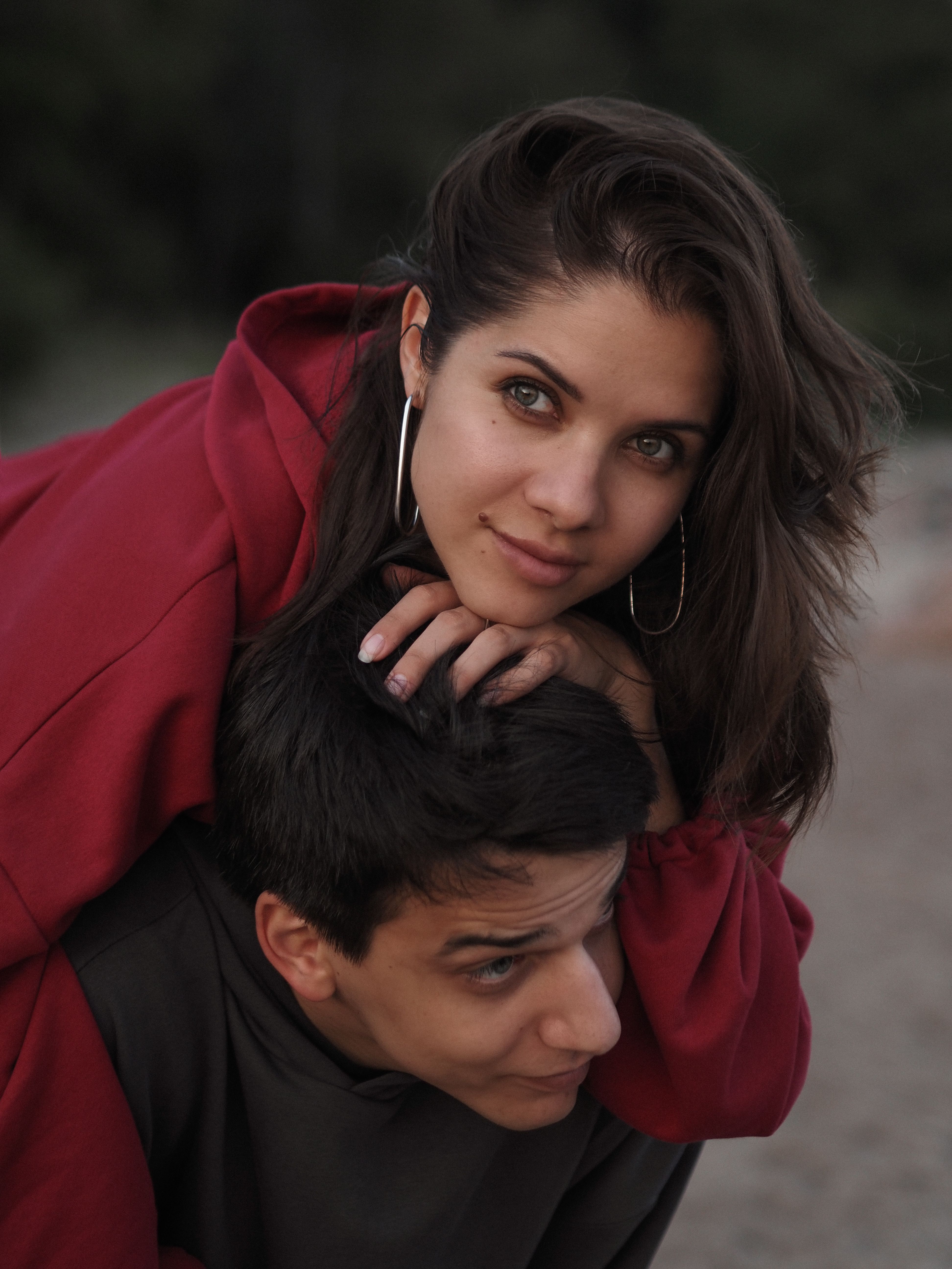 A joyful couple enjoying a playful moment outdoors at the beach.