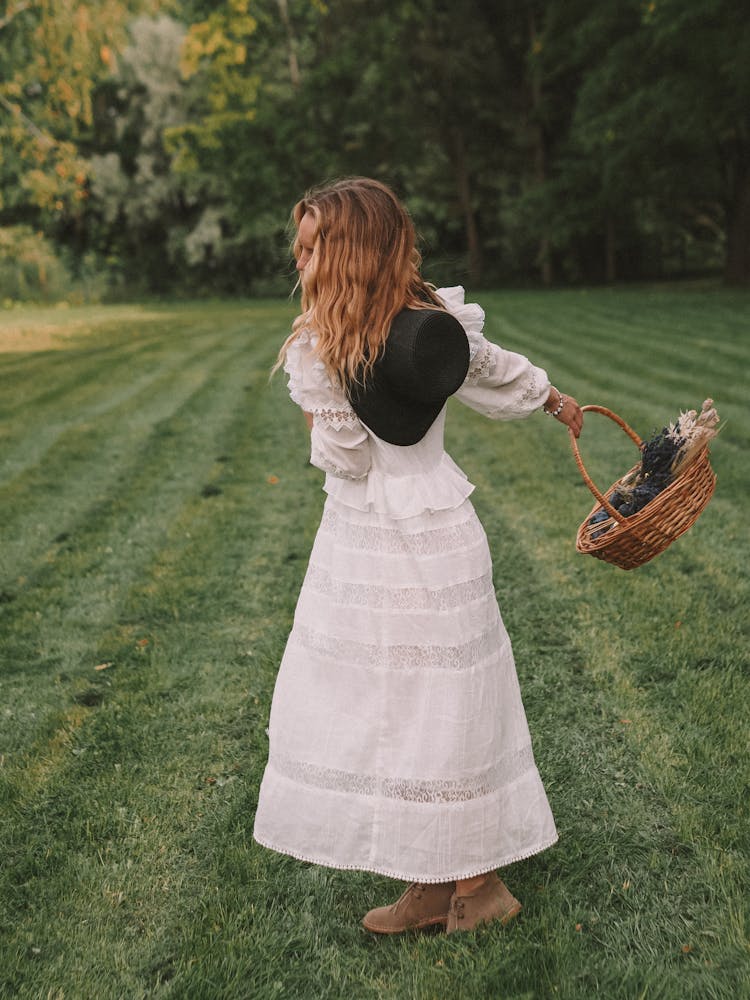 Woman Swinging Basket With Flowers