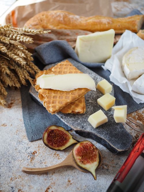Free Delicious breakfast spread with cheese, figs, and bread on a rustic surface. Stock Photo