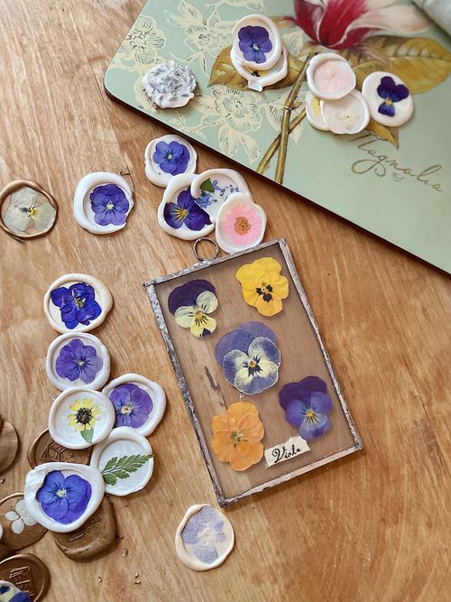 Free Vibrant flower wax seals and artwork arranged on a wooden surface, showcasing artistic creativity. Stock Photo